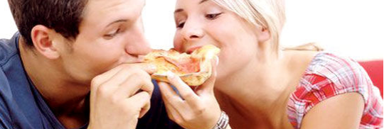 a woman eating a slice of pizza