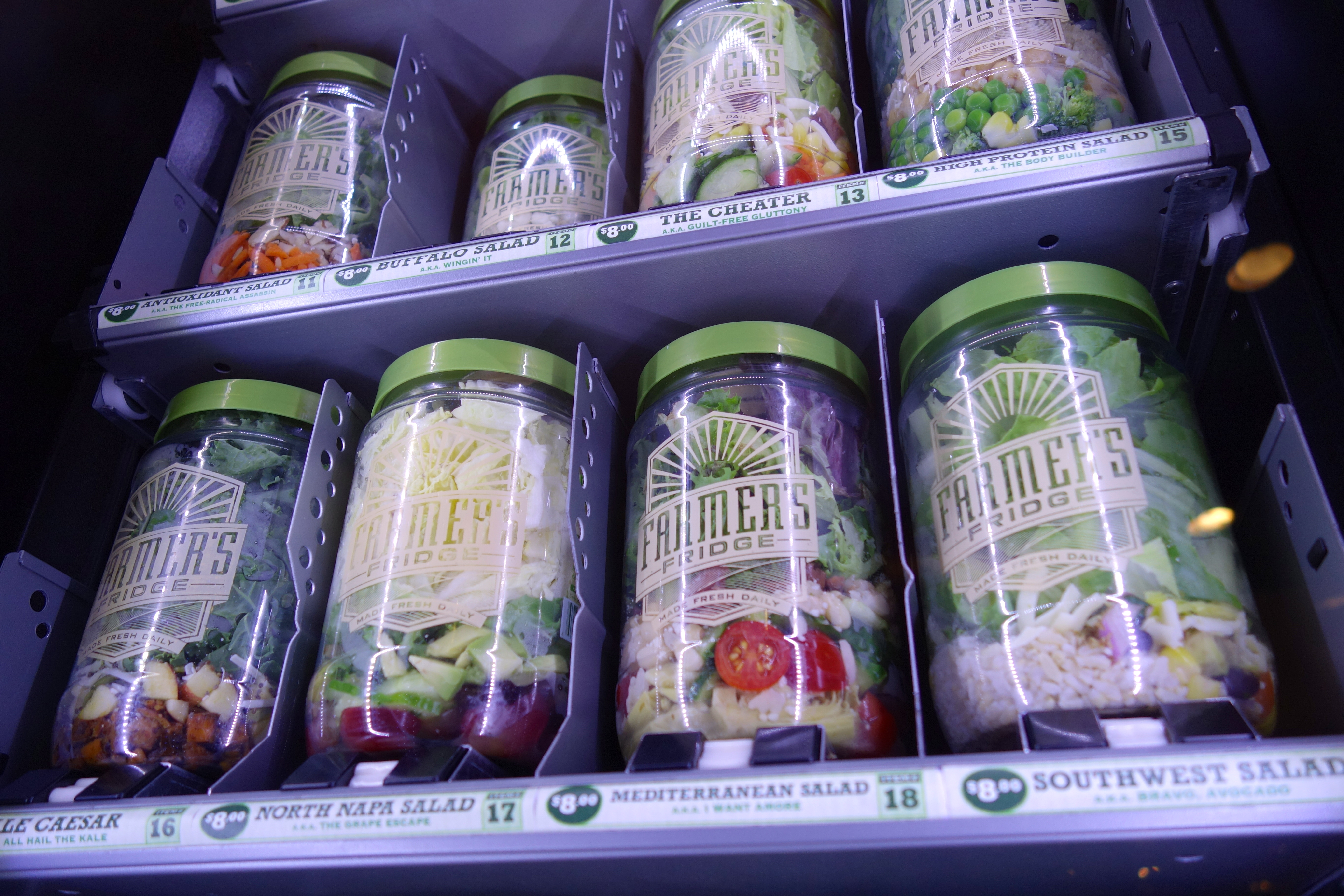 a shelf with jars of salads