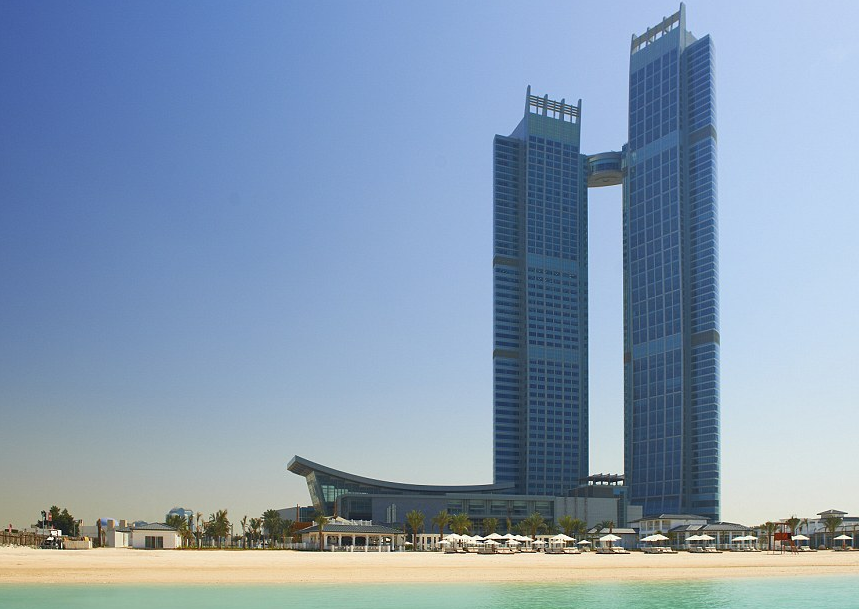 a tall building next to a beach