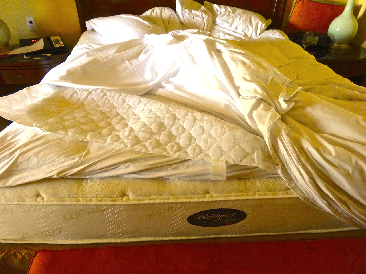 a mattress with a blanket on top