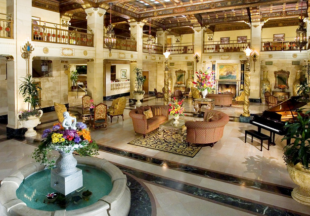 a large room with a fountain and furniture