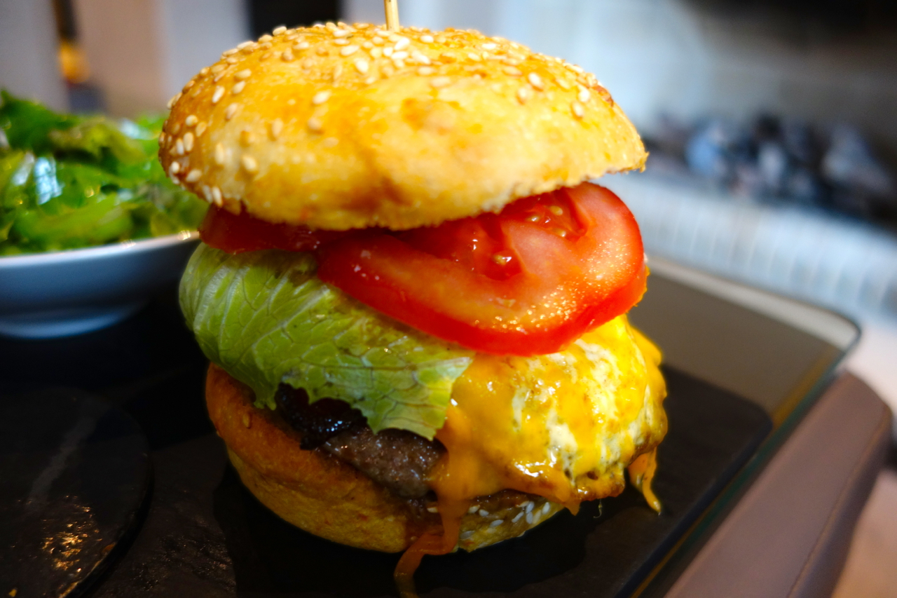 a burger with lettuce tomato and cheese