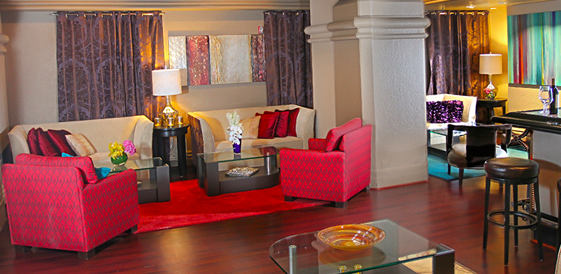 a living room with red couches and a glass coffee table