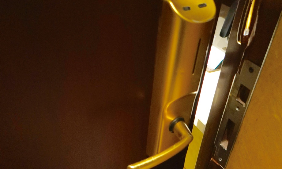 a gold door handle with a coin slot