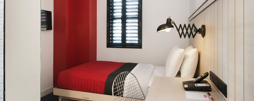 a bed with a red and black bedding