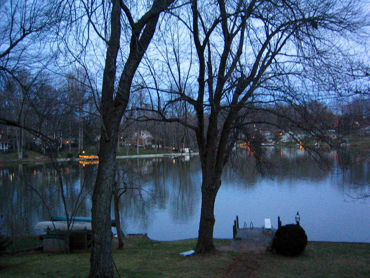 a lake with trees and a dock