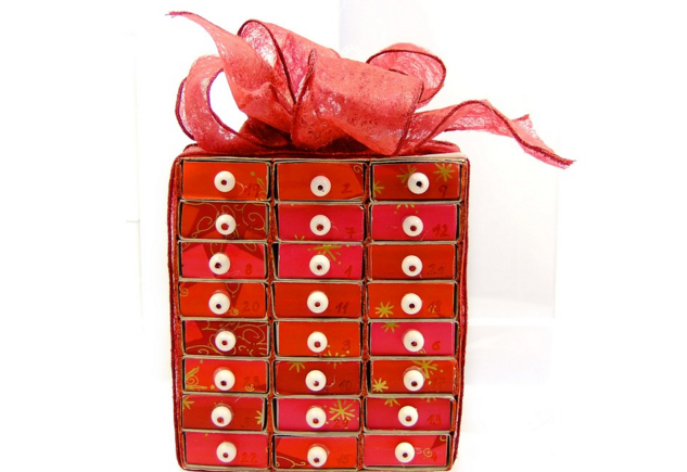 a red box with white buttons and a red bow