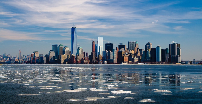 a city skyline with ice floating on the water
