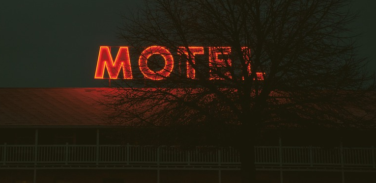 a red neon sign on a building