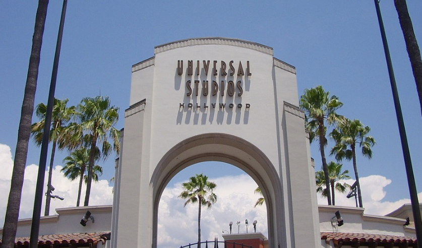 a large white archway with a sign