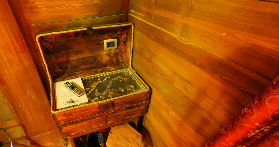 a wooden chest with a remote control and a key