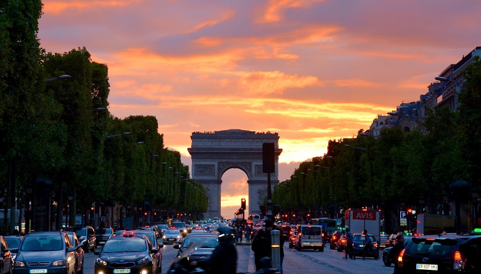 a traffic on a busy street with Champs-Élysées in the background