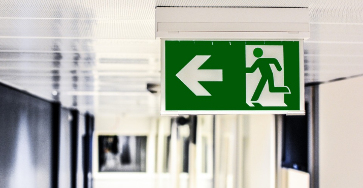 a green sign with a person walking on it