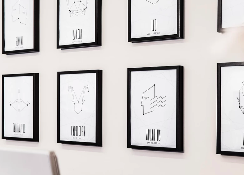 a wall with black frames and white text