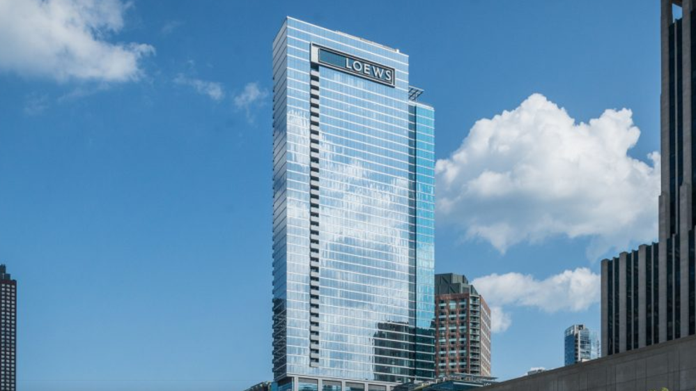 a tall building with a blue sky and clouds