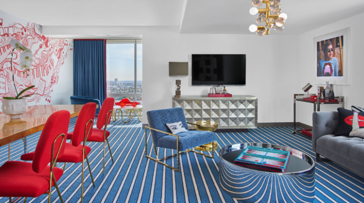 a room with a blue and white striped carpet and a blue chair