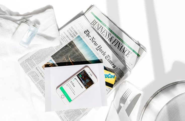 a newspaper and a phone on a table