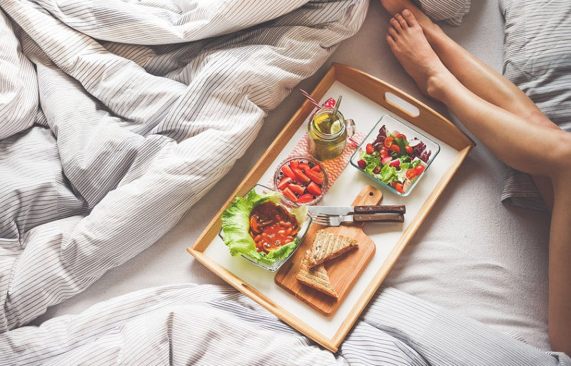 a tray with food on it and a person's feet