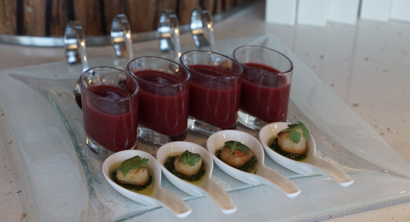 a group of glasses with sauces and scallops on them