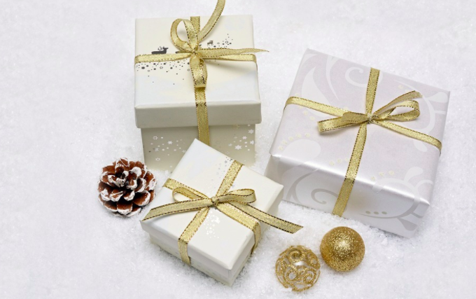 a group of wrapped presents with gold ribbon